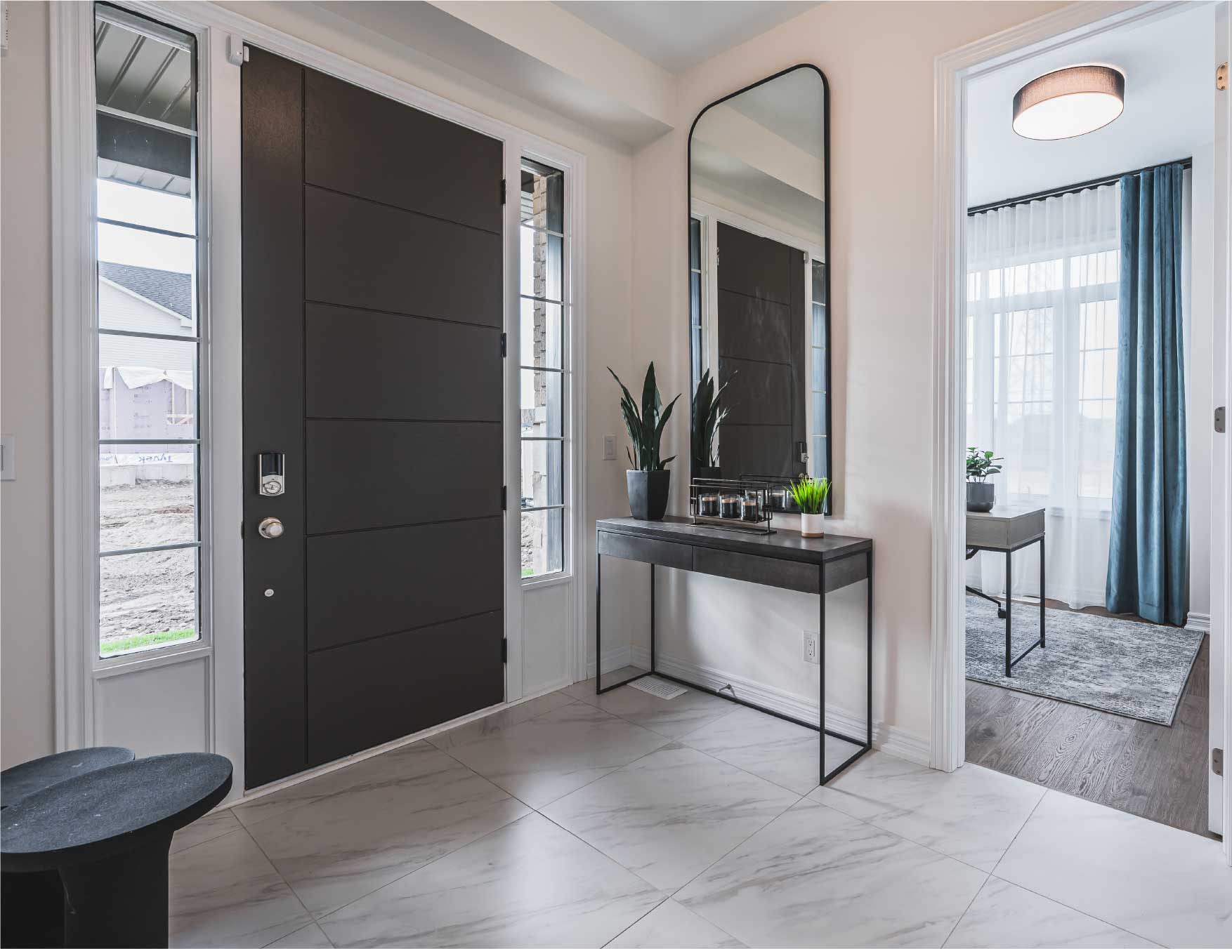 Modern entryway with front door and mirror